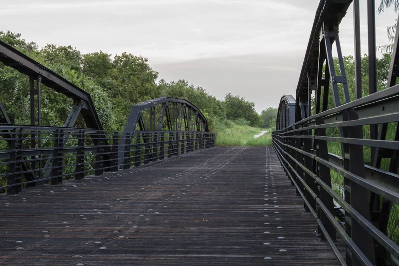 A pedestrian bridge over a creek along a trail in Cibolo, TX