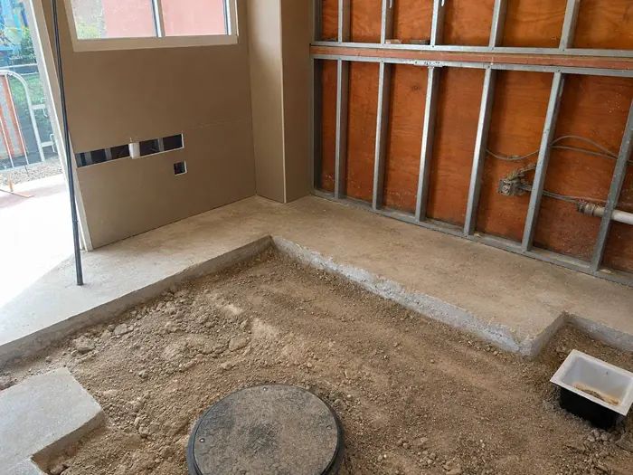 The same area after cleanup, with the piles of dirt and rubble cleared away and the floor leveled